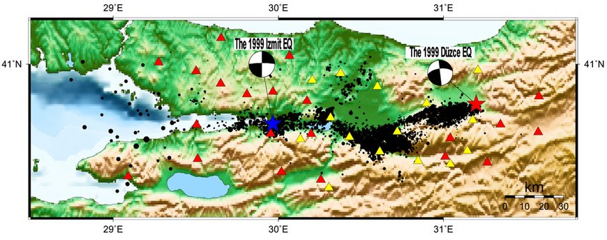 Izmit aftershock epicenters (black dots) along the rupture of the mainshock. The seismic stations are included [21 GTF (red) and 15 SABONET (yellow)]. For reference, the Izmit Mw = 7.4 and the Düzce Mw = 7.2 strike-slip focal mechanisms are plotted
