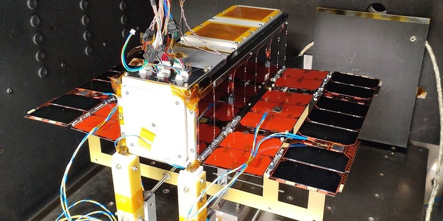 The small satellite is waiting to be used in the thermo-vacuum chamber, rectangular, wired, with small solar panels