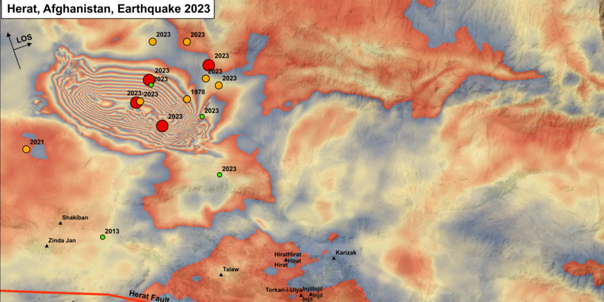 Map of northwestern Afghanistan around the earthquake area northwest of Herat. Deformations of the earth's surface are shown in bright colours - similar to a profile of contour lines. Dots mark the earthquake centres. There, ring-shaped patterns mark strong changes.