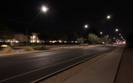 Street at night with dimmed street lights.