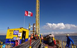 Drilling platform on Lake Junin with several people on it