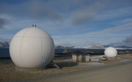 2 large spheres in the landscape. inside are the satellite receiving stations.