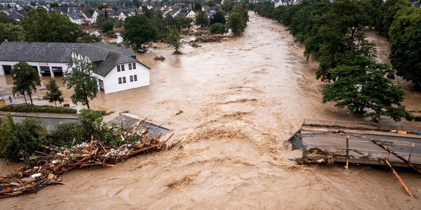 Luftbild eines überfluteten Dorfes im Ahrtal.