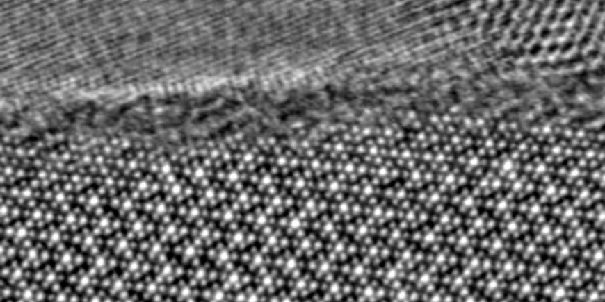 TEM image: below single dots represent the perfect crystal structure in atomic resolution, above the thin disordered amorphous layer. On top, the protective layer.