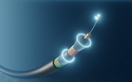 A fibre optic cable with a luminous tip surrounded by the blue ocean