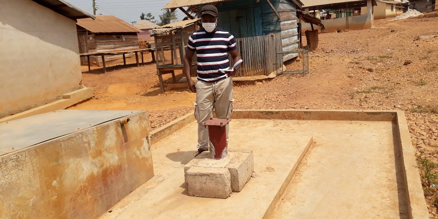 A concrete surface from which the connection of a borehole peeks out.
