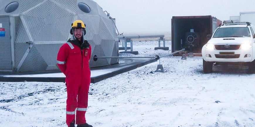 Martin Lipus stands in the snow in front of a scientific observatory in Iceland.