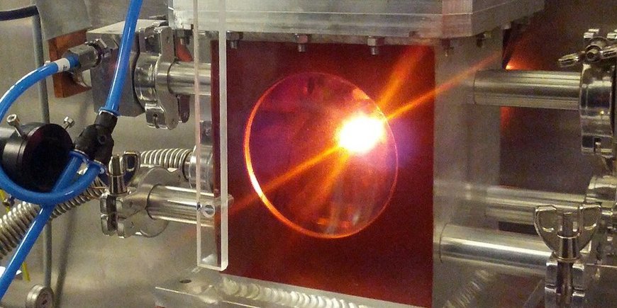 High pressure experiment. A bright light is seen in a metal device.