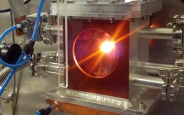 High pressure experiment. A bright light is seen in a metal device.